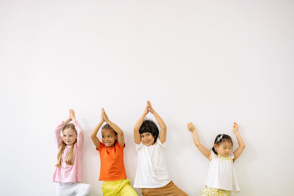 Diverse group of kids having fun in a yoga class.